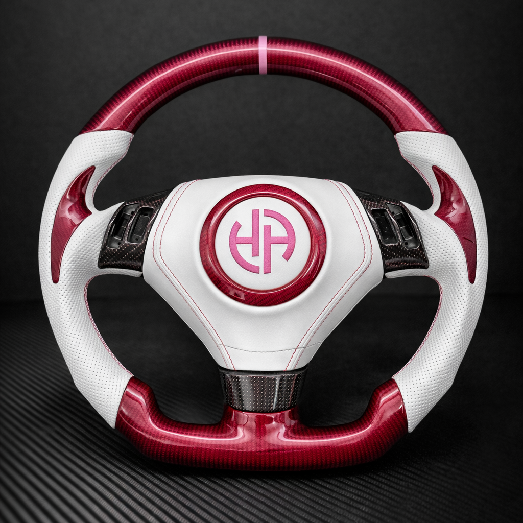 White and red steering wheel with a logo on a dark background