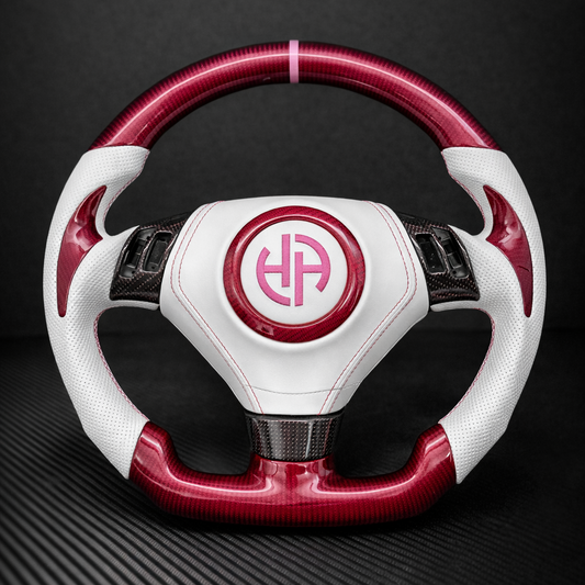White and red steering wheel with a logo on a dark background