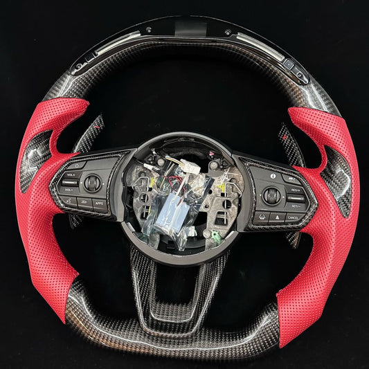 Car steering wheel with red and black design on a black background