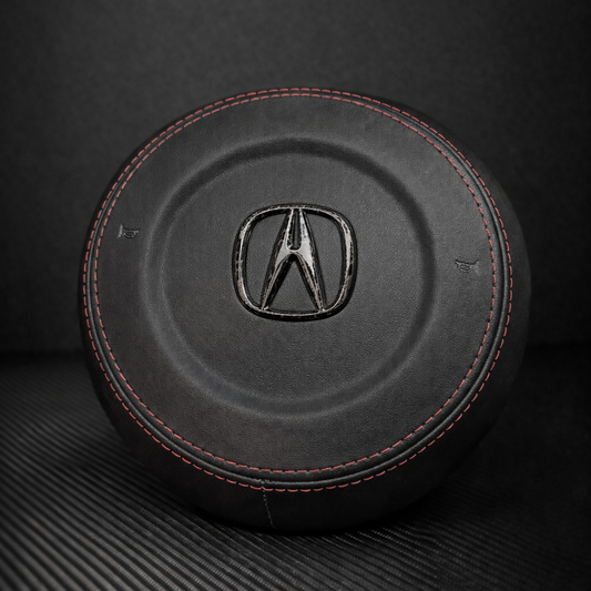 Black leather car seat cover with Acura logo on a dark background
