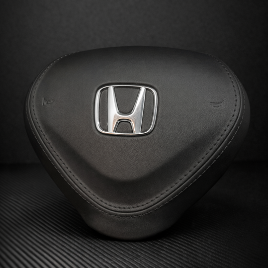 Black car headrest with Honda logo on a dark background